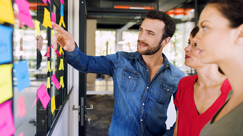 three people reviewing the plans for change