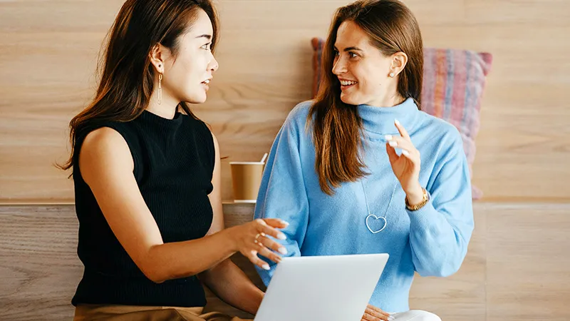 Leader providing constructive feedback in person meeting