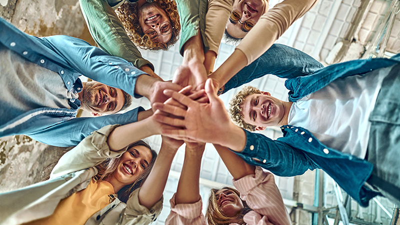 a group of people with their hands all in