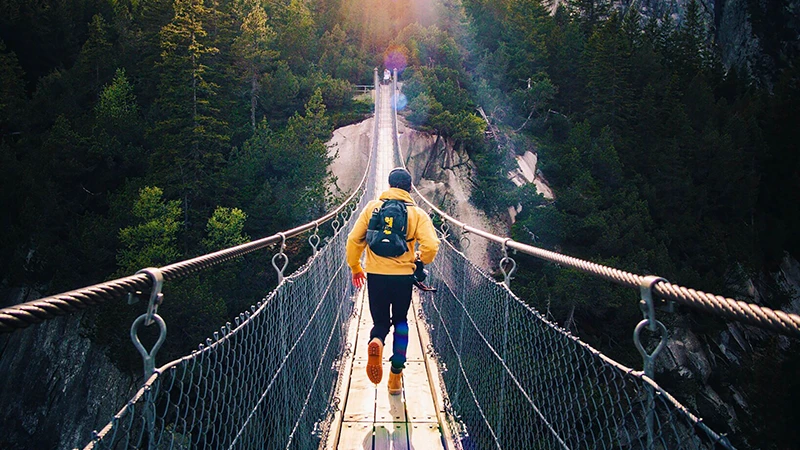 Man running across a bridge ready to take on the challenges of the new year