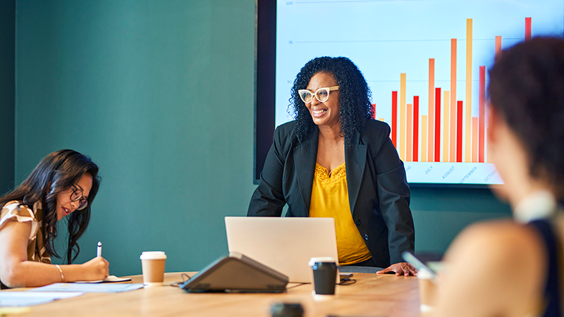 leader conquering imposter syndrome with confidence giving a presentation