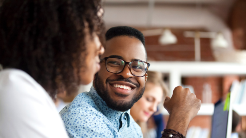boss and subordinate looking at each other and smiling