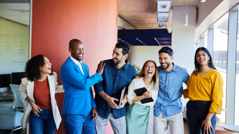 group of coworkers laughing and enjoying working together