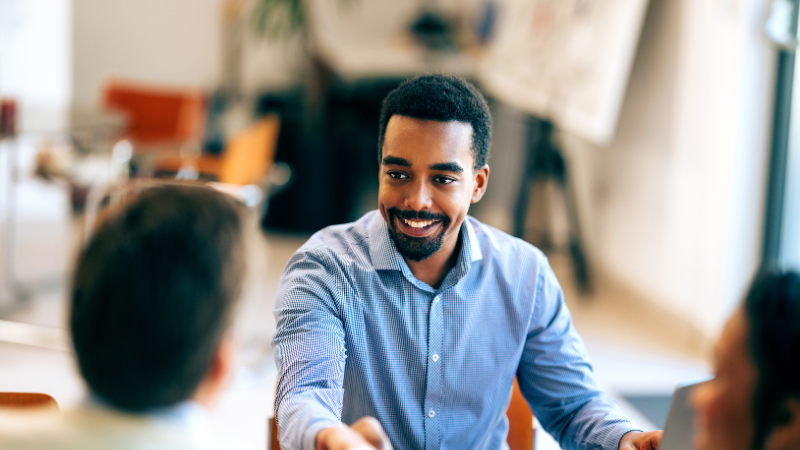 People shaking hands during an interview process.